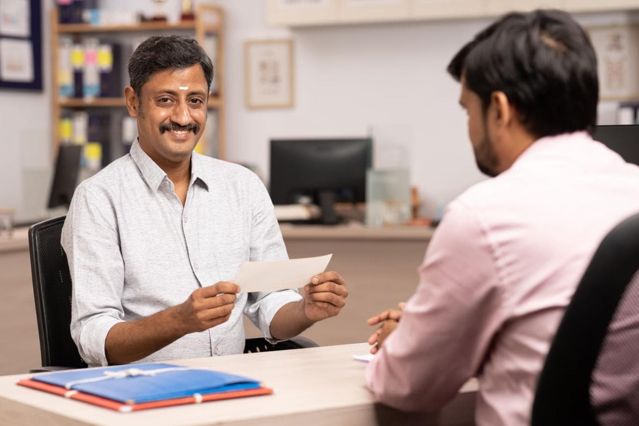 A business owner reviewing loan documents with an advisor